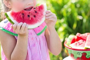 child eating watermelon during summer
