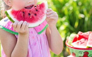 child eating watermelon during summer