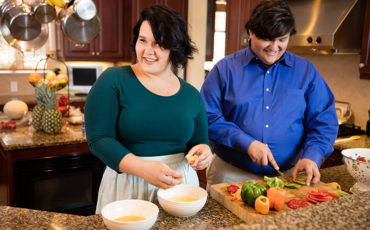 Man and woman in kitchen preparing food