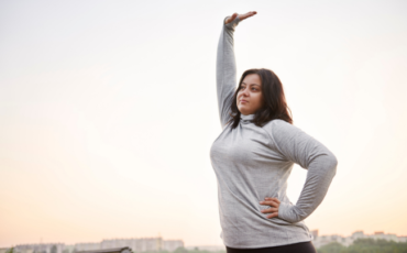 Getting back on the fitness wagon: Woman stretching outdoors