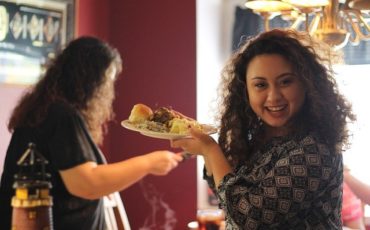 Blog image: Girl smiling holding food on Thanksgiving