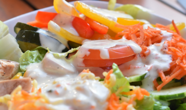 picture of salad with creamy salad dressing drizzled on top