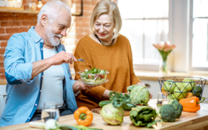 Seniors preparing a salad in the kitchen