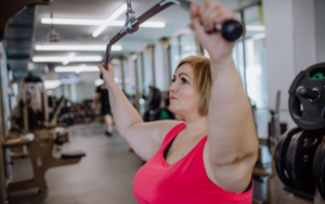 woman at gym pulling weights