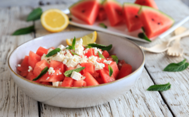 Bowl of watermelon, mint, feta salad with some fresh squeezed lemon