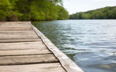 Serene photo of a dock on a lake, invoking feelings of calm.