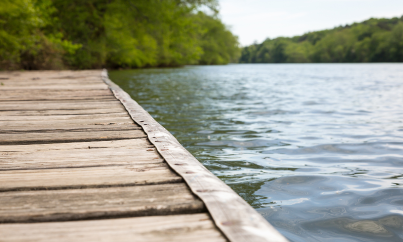 Serene photo of a dock on a lake, invoking feelings of calm.