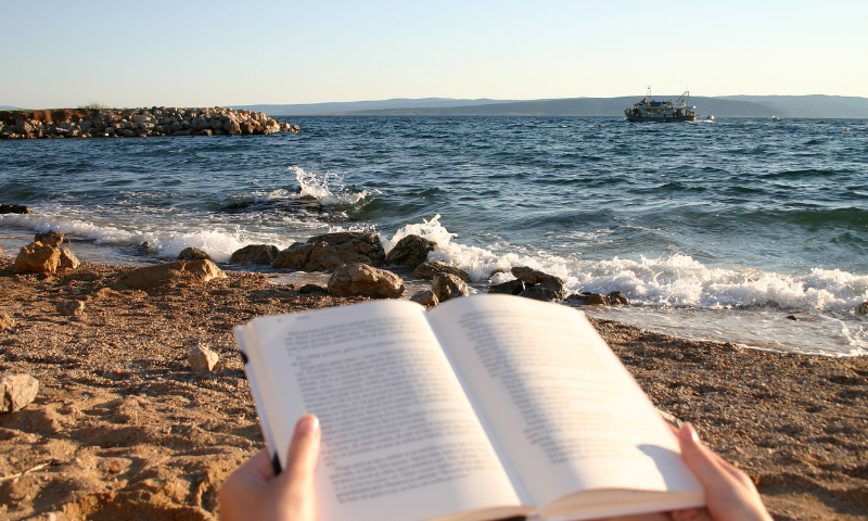 Reading a book on the beach