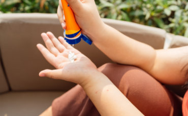 Photo of hands applying sunscreen