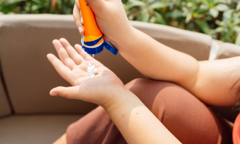 Photo of hands applying sunscreen