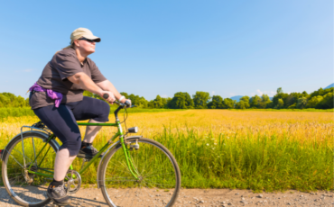 Middle age woman riding bike in summer