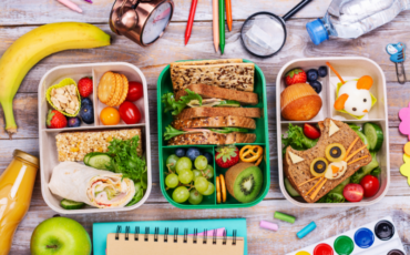 Healthy school lunches with colorful fruits, vegetables and whole grains