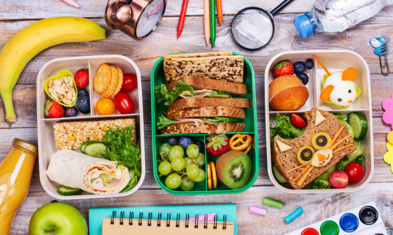 Healthy school lunches with colorful fruits, vegetables and whole grains