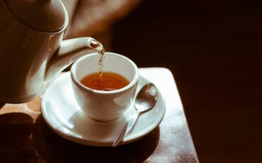 Image of a teapot filling a teacup with herbal tea