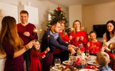 Holiday gathering around the table and in front of the Christmas tree